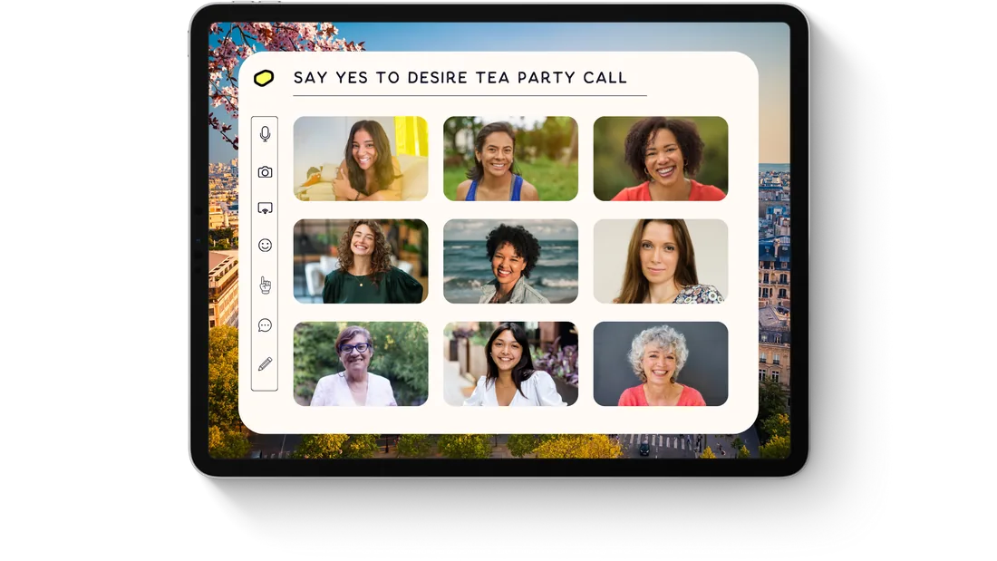 A Say Yes to Desire tea party call on a tablet, showing nine women together on a group video call